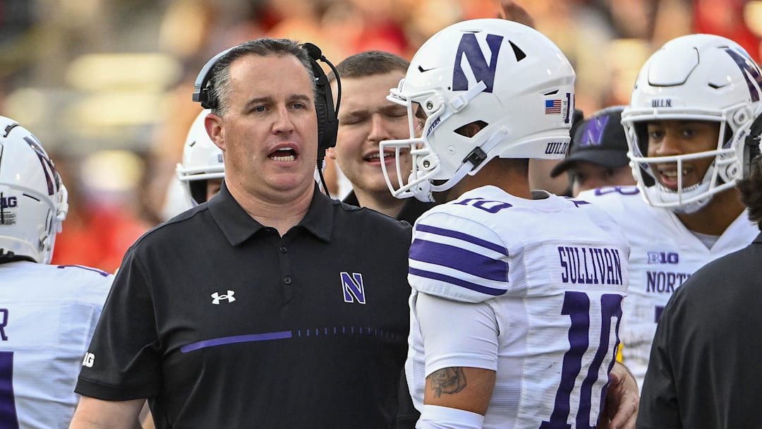 Oct 22, 2022; College Park, Maryland, USA; Northwestern Wildcats head coach Pat Fitzgerald talks with quarterback Brendan Sullivan (10) against the Maryland Terrapins at SECU Stadium. Mandatory Credit: Brad Mills-Imagn Images