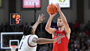 Feb 22, 2025; Spokane, Washington, USA; St. Mary's Gaels guard Augustas Marciulionis (3) shoots the ball against Gonzaga Bulldogs guard Michael Ajayi (1) in the second half at McCarthey Athletic Center. Mandatory Credit: James Snook-Imagn Images