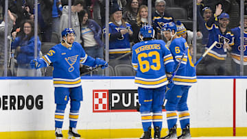 Nov 28, 2025; St. Louis, Missouri, USA; St. Louis Blues right wing Jordan Kyrou (25) celebrates with left wing Jake Neighbours (63) and defenseman Philip Broberg (6) after scoring against the Ottawa Senators during the third period at Enterprise Center. Mandatory Credit: Jeff Curry-Imagn Images