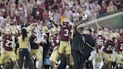 Florida State Seminoles running back Kam Davis and associate head coach Odell Haggins react after beating Alabama 