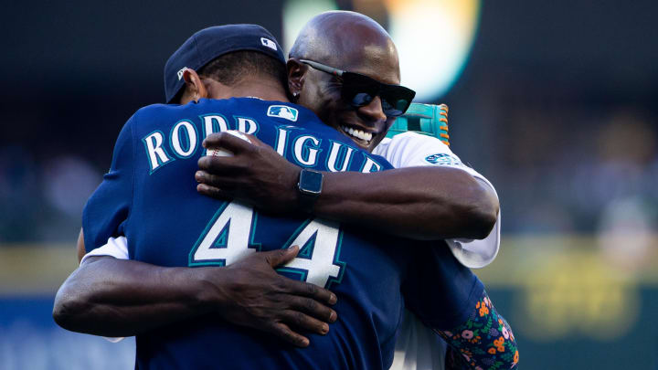 Seattle Mariners center fielder Julio Rodriguez hugs former Mariners player Mike Cameron before a game July 22, 2022.