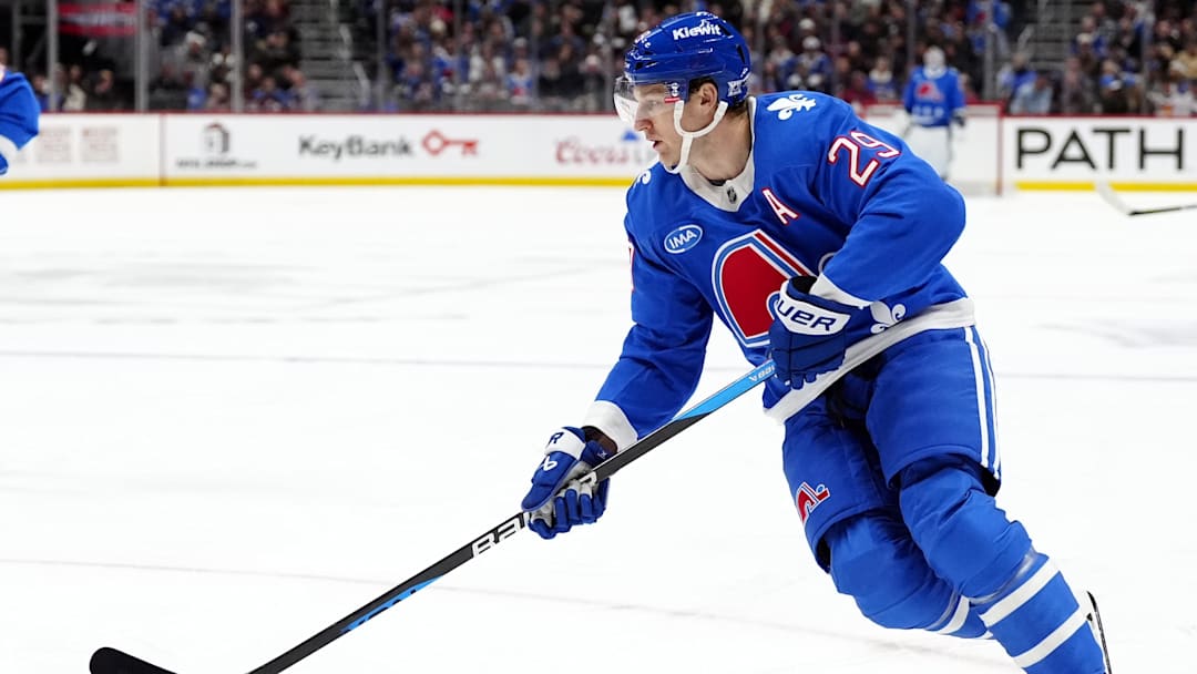 Nov 29, 2025; Denver, Colorado, USA; Colorado Avalanche center Nathan MacKinnon (29) controls the puck in the second period against the Montreal Canadiens at Ball Arena. Mandatory Credit: Ron Chenoy-Imagn Images