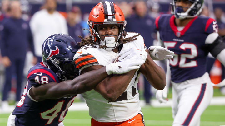 Jan 13, 2024; Houston, Texas, USA; Cleveland Browns running back Kareem Hunt (27) breaks the tackle of Houston Texans linebacker Christian Harris (48) as he scores a touchdown in a 2024 AFC wild card game at NRG Stadium. Mandatory Credit: Thomas Shea-USA TODAY Sports