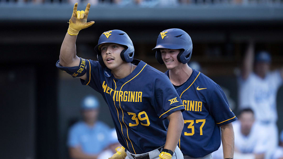 Jun 7, 2024; Chapel Hill, NC, USA; West Virginia Mountaineers Kyle West (39) motions to the dugout in front of teammate Grant Siegel (37) in the fifth inning of the DI Baseball Super Regional against the North Carolina Tar Heels at Boshamer Stadium.  Mandatory Credit: Jeffrey Camarati-Imagn Images