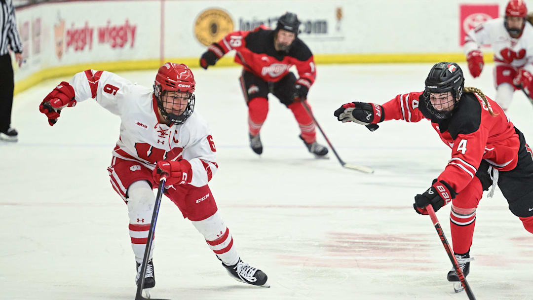 Wisconsin right wing Lacey Eden (6) advances the puck while Ohio State defender Sara Swinderski (4) pursues in a game Sunday, February 8, 2026, at LaBahn Arena in Madison, Wisconsin.