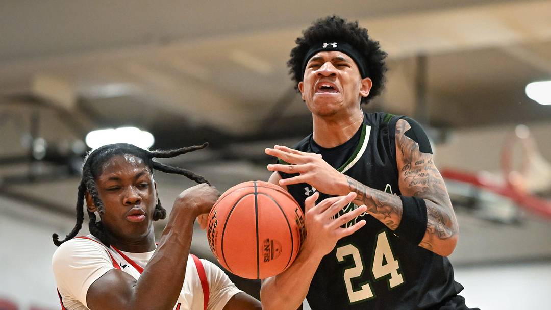 Wauwatosa West guard Jalen Brown (24) is tied up by Wauwatosa East guard/forward Tommie Muskgrow (4) on a drive in a game Friday, December 12, 2025, at Wauwatosa East High School in Wauwatosa, Wisconsin. West won 74-63.
