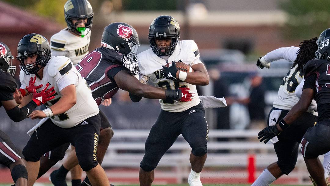 Warren Central High School senior Keyon Thomas (26) works to elude Warren Central High School defenders during the first half of an IHSAA varsity football game, Friday, Sept. 12, 2025, at Lawrence Central High School.