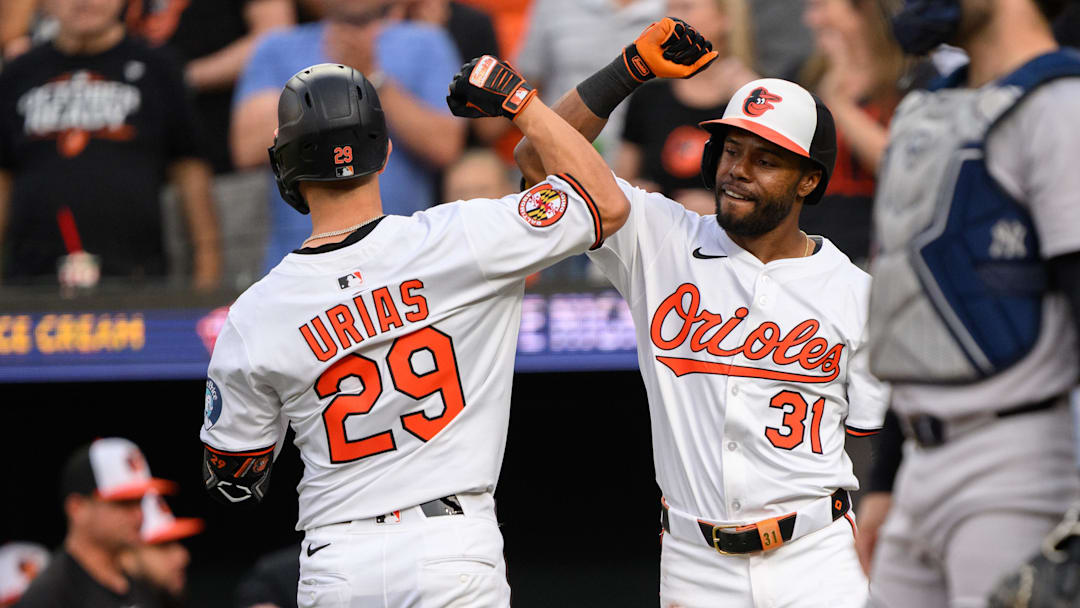 Apr 30, 2025; Baltimore, Maryland, USA; Baltimore Orioles third baseman Ramon Urias (29) celebrates with outfielder Cedric Mullins (31) after hitting a home run during the second inning against the New York Yankees at Oriole Park at Camden Yards. Mandatory Credit: Reggie Hildred-Imagn Images