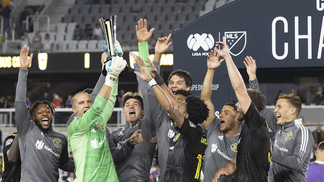 Sep 29, 2021; Columbus, OH, USA; Columbus Crew goalkeeper Evan Bush (24) holds the trophy surrounded by teammates after defeating Cruz Azul to win  the 2021 Campeones Cup match at Lower.com Field Mandatory Credit: Greg Bartram-USA TODAY Sports