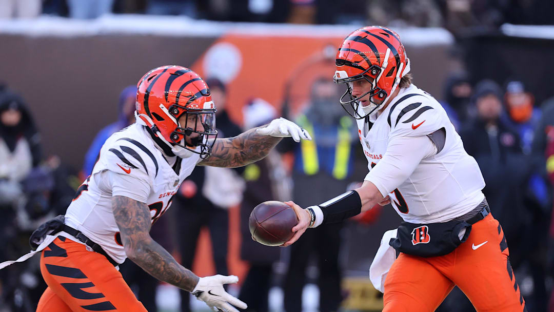Dec 14, 2025; Cincinnati, Ohio, USA; Cincinnati Bengals quarterback Joe Burrow (9) hands off to running back Chase Brown (30) during the second quarter against the Baltimore Ravens at Paycor Stadium. Mandatory Credit: Joseph Maiorana-Imagn Images