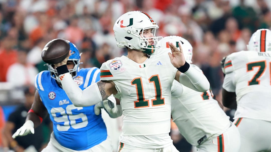 Jan 8, 2026; Glendale, AZ, USA; Miami Hurricanes quarterback Carson Beck (11) drops back to pass against the Mississippi Rebels in the first half during the 2026 Fiesta Bowl and semifinal game of the College Football Playoff at State Farm Stadium. Mandatory Credit: Mark J. Rebilas-Imagn Images