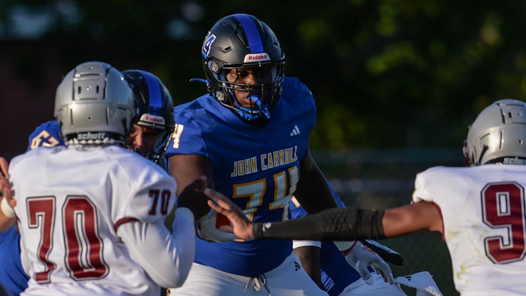 John Carroll's Sean Tatum (74) helps block Palm Beach Lakes defenders during their game at John Carroll High School on Friday, Aug. 16, 2024, in Fort Pierce.