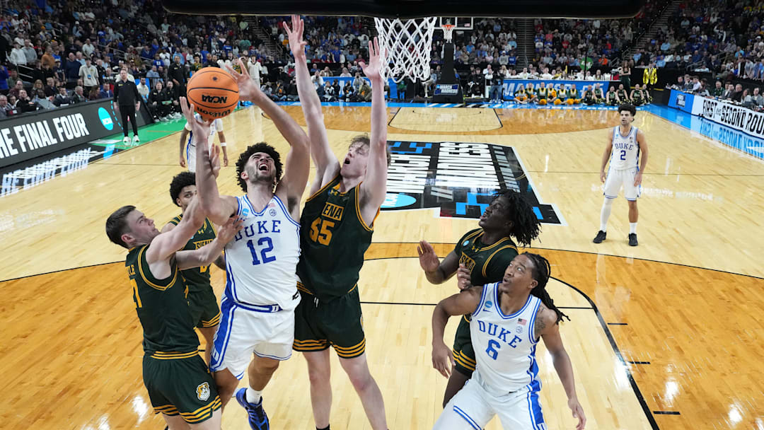 Mar 19, 2026; Greenville, SC, USA; Duke Blue Devils forward Cameron Boozer (12) shoots the ball over Siena Saints center Riley Mulvey (55) in the second half during a first round game of the men's 2026 NCAA Tournament at Bon Secours Wellness Arena. Mandatory Credit: Bob Donnan-Imagn Images