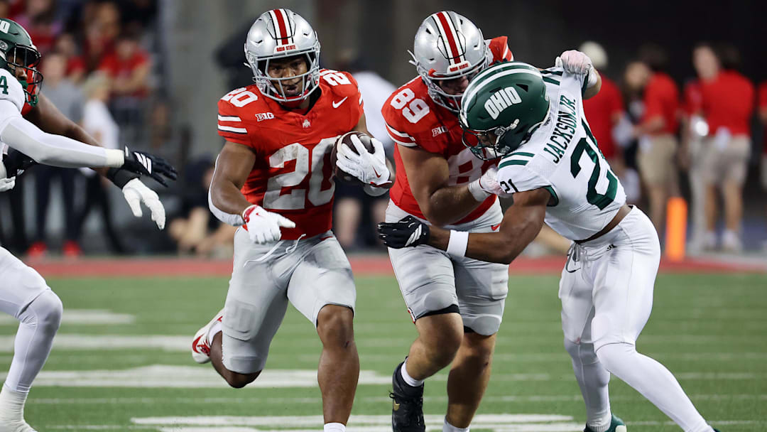 Sep 13, 2025; Columbus, Ohio, USA;  Ohio State Buckeyes running back James Peoples (20) runs the ball as Ohio Bobcats defensive back Ronald Jackson Jr. (21) makes the tackle during the second half at Ohio Stadium. Mandatory Credit: Joseph Maiorana-Imagn Images