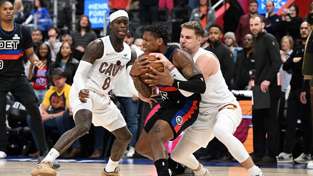 Feb 27, 2026; Detroit, Michigan, USA;  Cleveland Cavaliers guard Sam Merrill (5) ties up Detroit Pistons guard Marcus Sasser (25) for a jump ball as Cleveland Cavaliers guard Dennis Schroder (8) looks on in overtime at Little Caesars Arena. Mandatory Credit: Lon Horwedel-Imagn Images