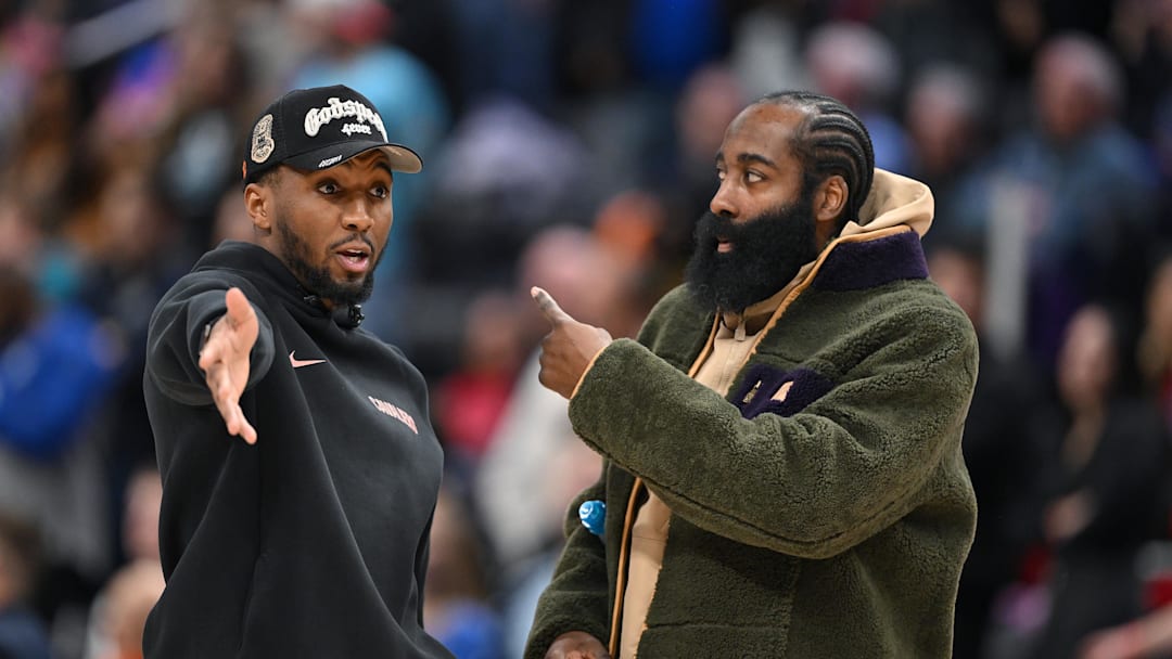 Feb 27, 2026; Detroit, Michigan, USA;   Cleveland Cavaliers guard Donovan Mitchell (left) talks with teammate James Harden during a timeout against the Detroit Pistons in the second half at Little Caesars Arena. Neither played in their overtime loss to the Pistons. Mandatory Credit: Lon Horwedel-Imagn Images