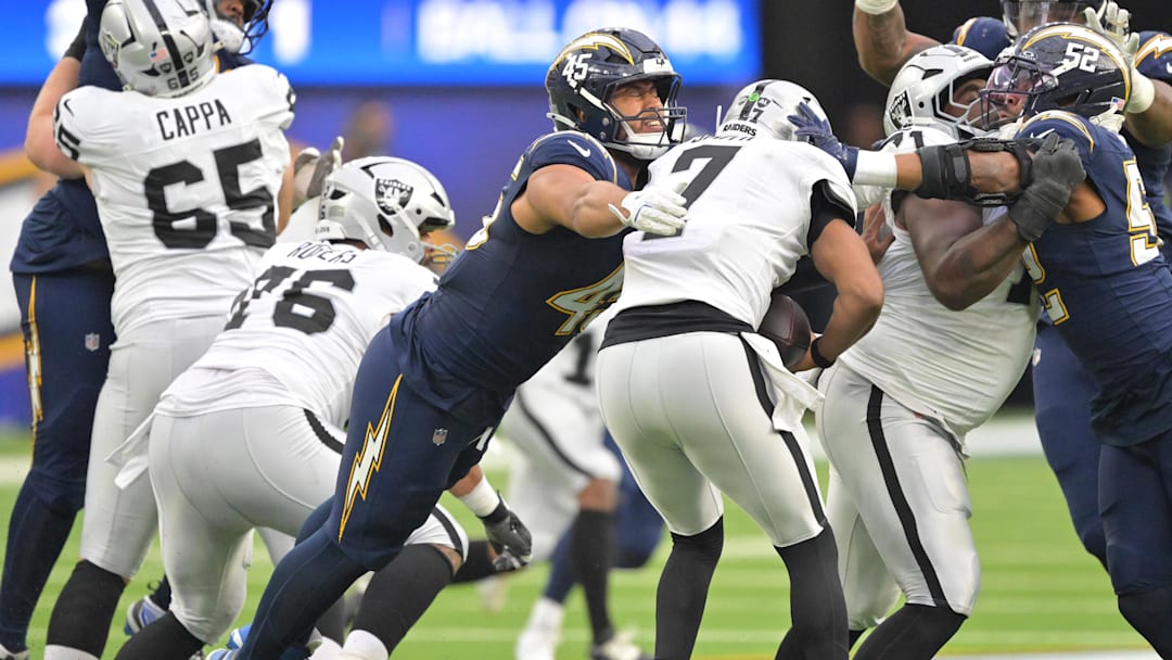 Nov 30, 2025; Inglewood, California, USA; Los Angeles Chargers linebacker Tuli Tuipulotu (45) sacks Las Vegas Raiders quarterback Geno Smith (7) during the second half at SoFi Stadium. Mandatory Credit: Jayne Kamin-Oncea-Imagn Images