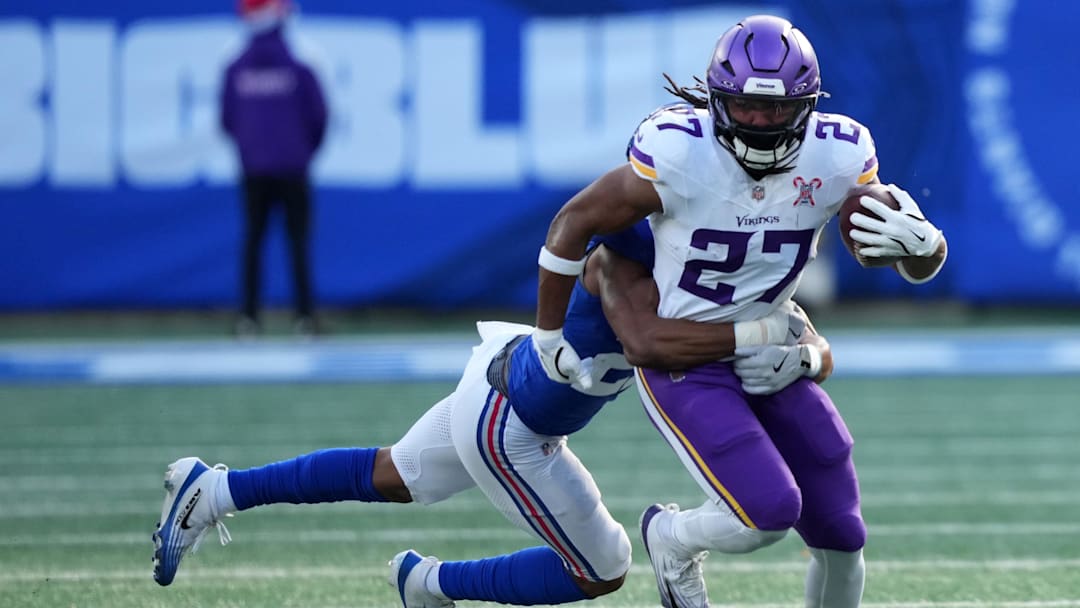Dec 21, 2025; East Rutherford, New Jersey, USA; Minnesota Vikings running back Jordan Mason (27) rushes the ball against the New York Giants during the first half at MetLife Stadium. Mandatory Credit: Robert Deutsch-Imagn Images