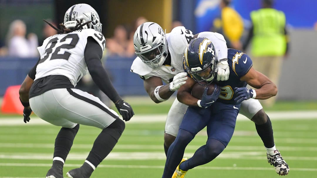 Nov 30, 2025; Inglewood, California, USA; Las Vegas Raiders linebacker Devin White (45) tackles Los Angeles Chargers wide receiver Tre' Harris (9) during the second half at SoFi Stadium. Mandatory Credit: Jayne Kamin-Oncea-Imagn Images