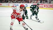 Wisconsin Badgers defender Caroline Harvey (4) makes a pass to set up a goal by Casey O'Brien (not seen) against the Bemidji State Beavers in the first period of a WCHA first-round game Saturday, March 1, 2025, at LaBahn Arena in Madison, Wisconsin.