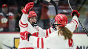 Wisconsin Badgers center Casey O'Brien (26) and defender Caroline Harvey (4) celebrate O’Brien’s goal against the Bemidji State Beavers in the first period of a WCHA first-round game Saturday, March 1, 2025, at LaBahn Arena in Madison, Wisconsin.