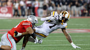 Oct 4, 2025; Columbus, Ohio, USA; Minnesota Golden Gophers running back Darius Taylor (1) runs the ball as Ohio State Buckeyes defensive lineman Maxwell Roy (93) makes the tackle during the second quarter at Ohio Stadium. Mandatory Credit: Joseph Maiorana-Imagn Images
