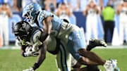 Nov 22, 2025; Chapel Hill, North Carolina, USA; Duke Blue Devils wide receiver Sahmir Hagans (2) is tackled after a catch by North Carolina Tar Heels defensive back Jaiden Patterson (18) during the second half at Kenan Stadium. Mandatory Credit: William Howard-Imagn Images