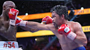 Manny Pacquiao (right) fights Yordenis Ugas in a world welterweight championship bout at T-Mobile Arena. 