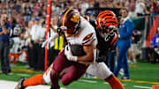 Washington Commanders running back Austin Ekeler (30) is tackled by Cincinnati Bengals safety Geno Stone (22) in the 2nd quarter during Monday Night Football on September 23, 2024 at Paycor Stadium. The Bengals lost 38-33.