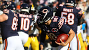 Nov 23, 2025; Chicago, Illinois, USA; Chicago Bears quarterback Caleb Williams (18) rushes the ball for a first down on fourth down during the second half at Soldier Field.