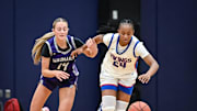 Wisconsin Lutheran's Londyn Hollins (24) outraces Waunakee guard Ashlyn Bauer (14) to a loose ball in a game in the Kettle Moraine Thanksgiving Classic on Friday, November 28, 2025, at the Kettle Moraine High School in Wales, Wisconsin.