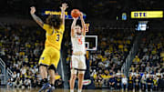 Mar 2, 2025; Ann Arbor, Michigan, USA; Illinois Fighting Illini forward Jake Davis (15) shoots a three point shot over Michigan Wolverines guard Tre Donaldson (3) in the second half at Crisler Center. Mandatory Credit: Lon Horwedel-Imagn Images