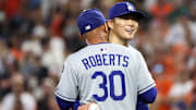 Sep 6, 2025; Baltimore, Maryland, USA; Los Angeles Dodgers pitcher Yoshinobu Yamamoto (18) celebrates with Los Angeles Dodgers manager Dave Roberts (30) during the ninth inning against the Baltimore Orioles at Oriole Park at Camden Yards. Mandatory Credit: Daniel Kucin Jr.-Imagn Images