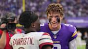 Dec 7, 2025; Minneapolis, Minnesota, USA; Minnesota Vikings quarterback J.J. McCarthy (9) reacts with Washington Commanders cornerback Mike Sainristil (0) after the game at U.S. Bank Stadium. Mandatory Credit: Brad Rempel-Imagn Images
