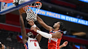 Oct 16, 2025; Detroit, Michigan, USA; Detroit Pistons center Jalen Duren (0) has his shot blocked at the basket by Washington Wizards center Alex Sarr (20) in the first quarter at Little Caesars Arena. Mandatory Credit: Lon Horwedel-Imagn Images