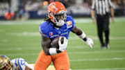 Dec 16, 2023; Inglewood, CA, USA; Boise State Broncos running back Ashton Jeanty (2) slips a tackle by UCLA Bruins linebacker Darius Muasau (53) during the first quarter of the Starco Brands LA Bowl at SoFi Stadium. Mandatory Credit: Robert Hanashiro-Imagn Images