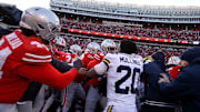Nov 30, 2024; Columbus, Ohio, USA;  Police attempt to break up Ohio State Buckeyes players and Michigan Wolverines players as they fight after the game at Ohio Stadium. Mandatory Credit: Joseph Maiorana-Imagn Images