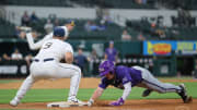 Logan Maxwell diving back into first base. 