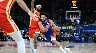 Dec 12, 2025; Detroit, Michigan, USA; Detroit Pistons guard Cade Cunningham (2) drives past Atlanta Hawks guard Nickeil Alexander-Walker (7) in the first quarter at Little Caesars Arena. Mandatory Credit: Lon Horwedel-Imagn Images