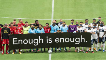 Toronto FC and Vancouver Whitecaps FC hold Enough is enough sign at MLS match