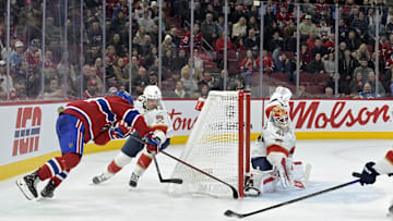 Apr 1, 2025; Montreal, Quebec, CAN;Montreal Canadiens forward Nick Suzuki (14) scores the winning goal against Florida Panthers goalie Vitek Vanecek (41) during the overtime period at the Bell Centre. Mandatory Credit: Eric Bolte-Imagn Images