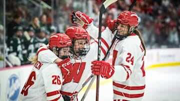 Wisconsin Badgers left wing Kirsten Simms (27) celebrates her second goal with center Casey O'Brien (26) and defender Katie Kotlowski (24) against the Bemidji State Beavers in the first period of a WCHA first-round game Saturday, March 1, 2025, at LaBahn Arena in Madison, Wisconsin.