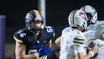 Liberty Hill Panthers defensive end Alister Vallejo (56) chases Rouse Raiders quarterback London Morgan (1) during a play in the fourth quarter at the non-district Class 5A football game on Friday, Sept 6, 2024, at Liberty Hill Panther Stadium in Liberty Hill, TX.