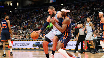 Dec 30, 2024; Washington, District of Columbia, USA; Washington Wizards center Jonas Valanciunas (17) handles the ball against New York Knicks guard Miles McBride (2) during the third quarter at Capital One Arena. Mandatory Credit: Reggie Hildred-Imagn Images