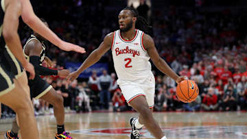 Feb 18, 2024; Columbus, Ohio, USA;  Ohio State Buckeyes guard Bruce Thornton (2) controls the ball as Purdue Boilermakers guard Ethan Morton (25) defends during the second half at Value City Arena. Mandatory Credit: Joseph Maiorana-Imagn Images