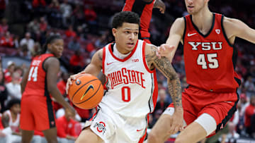 Nov 11, 2024; Columbus, Ohio, USA;  Ohio State Buckeyes guard John Mobley Jr. (0) drives past Youngstown State Penguins center Gabe Dynes (45) during the second half at Value City Arena. Mandatory Credit: Joseph Maiorana-Imagn Images