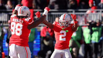 Nov 30, 2024; Columbus, Ohio, USA; Ohio State Buckeyes safety Caleb Downs (2) celebrates a fourth down stop with Ohio State Buckeyes defensive lineman Kayden McDonald (98) during the first quarter against the Michigan Wolverines at Ohio Stadium. Mandatory Credit: Joseph Maiorana-Imagn Images