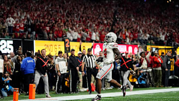 Ohio State Buckeyes wide receiver Jeremiah Smith (4) scores a touchdown after a catch against Notre Dame Fighting Irish in the first quarter during the College Football Playoff National Championship at Mercedes-Benz Stadium in Atlanta on January 20, 2025.