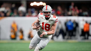 Ohio State Buckeyes quarterback Will Howard (18) runs the ball against Notre Dame Fighting Irish in the third quarter during the College Football Playoff championship at Mercedes-Benz Stadium in Atlanta on January 20, 2025.