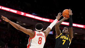 Jan 27, 2025; Columbus, Ohio, USA;  Iowa Hawkeyes forward Seydou Traore (7) shoots the ball as Ohio State Buckeyes guard Micah Parrish (8) defends during the first half at Value City Arena. Mandatory Credit: Joseph Maiorana-Imagn Images